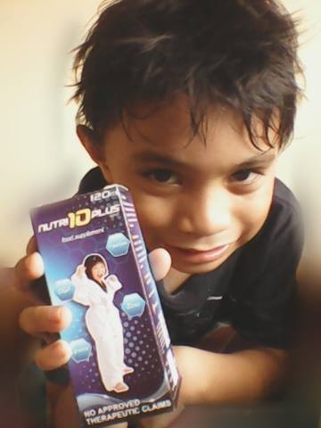 a kid holding a Nutri10 Plus food supplement